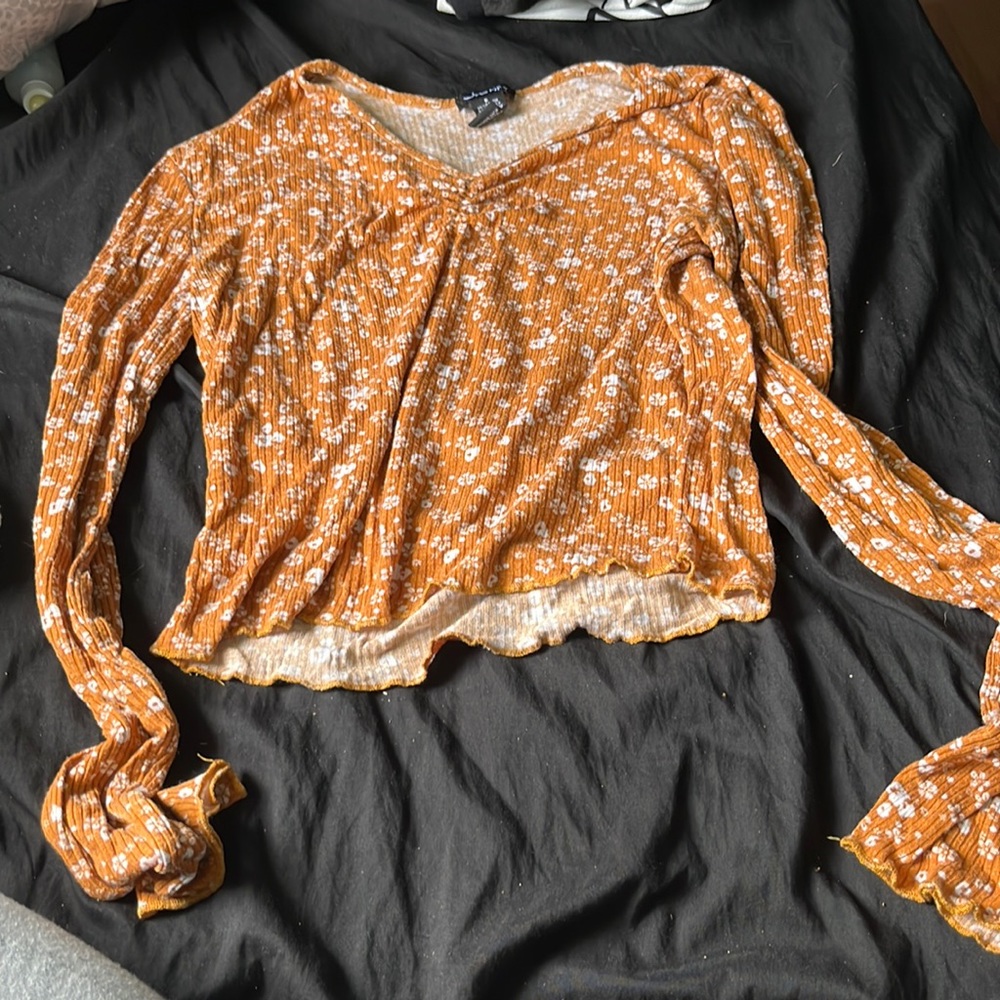 burnt orange crop top with flowers on it